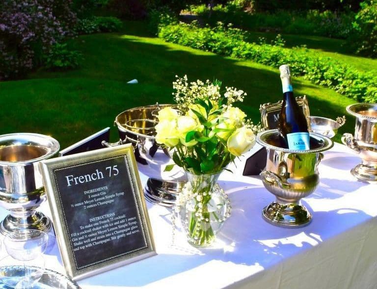 Outdoor party table with wine and flowers
