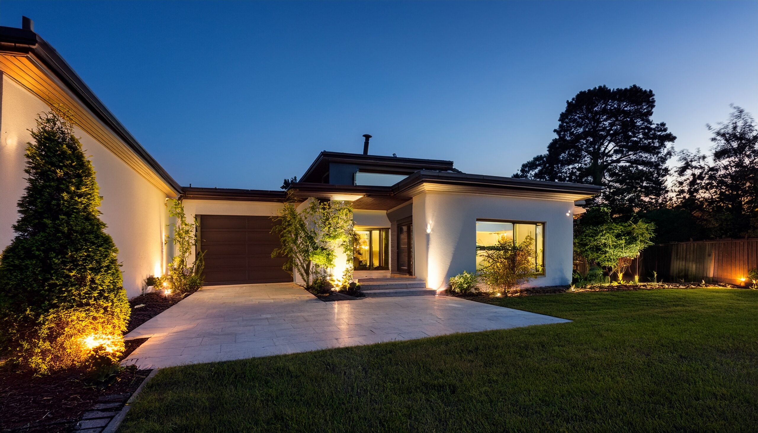 Properly designed landscape lighting illuminating a North Shore property at night