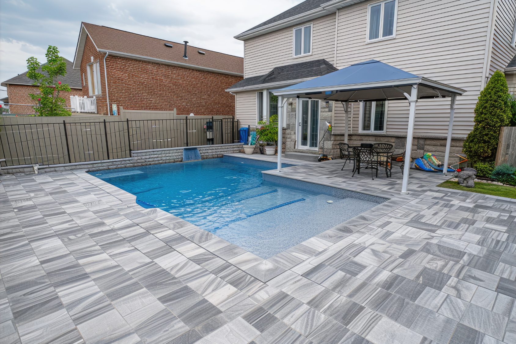 Pool patio with bluestone surround and landscape design on a North Shore Massachusetts property by Cole Landscaping